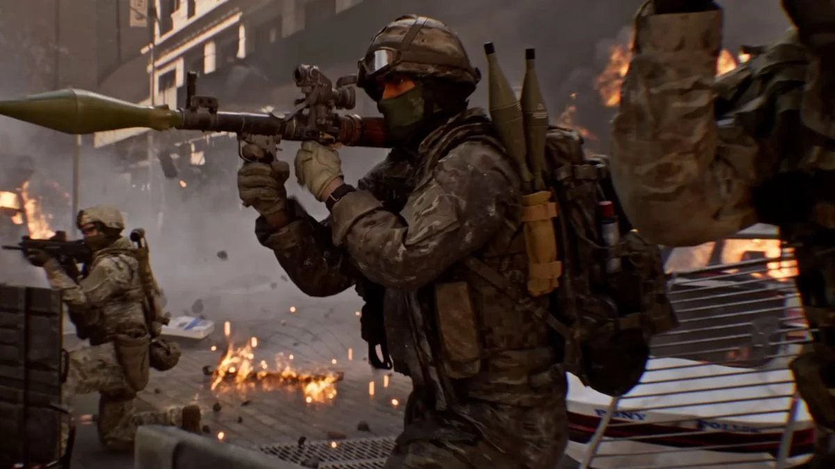 battlefield-6-veroffentlichungstermin-beta-daten-und-gameplay-details_img_0 | etalongame.de Soldat aus dem Battlefield 6 Trailer, gekleidet in grüner Tarnung und größtenteils bedeckt außer den Augen. Er hält eine RPG und zeigt vom Bildschirm weg.